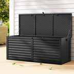 Black outdoor storage box with a lattice design on a wooden deck.
