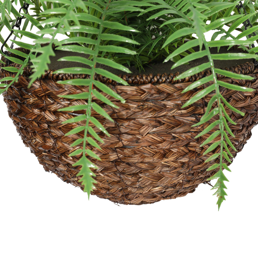 Woven basket with green fern leaves on a white background