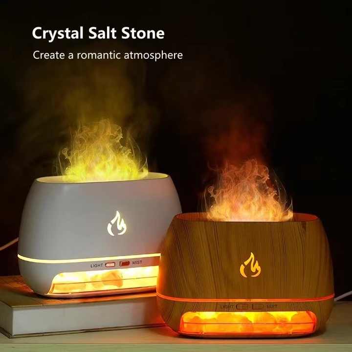 Two crystal salt stone diffusers with flame design on a dark background